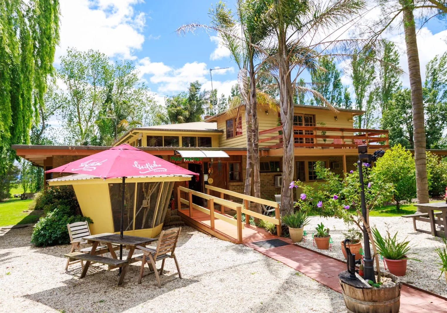 Sunny courtyard with outdoor seating at Tinamba country accommodation, Happy Days
